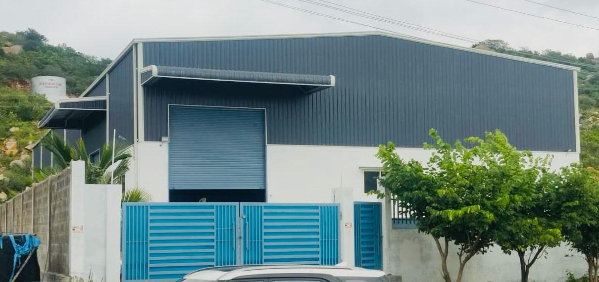 Blue and white industrial warehouse structure with corrugated metal roof